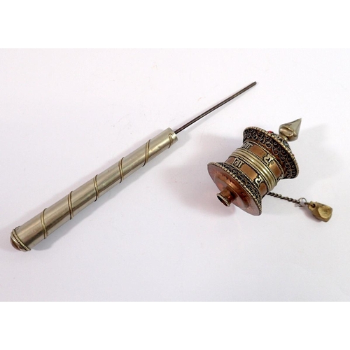 1090 - A Tibetan white metal prayer wheel, 17cm long