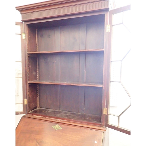 1164 - A Georgian mahogany bureau bookcase of small proportions with astragal glazed doors over slope front... 