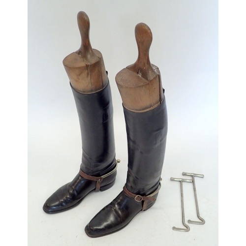 1170 - A pair of early 20th century black leather riding boots with wooden trees and boot jacks