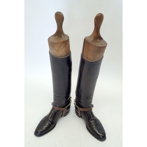 1170 - A pair of early 20th century black leather riding boots with wooden trees and boot jacks