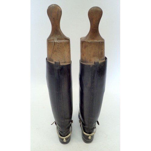 1170 - A pair of early 20th century black leather riding boots with wooden trees and boot jacks