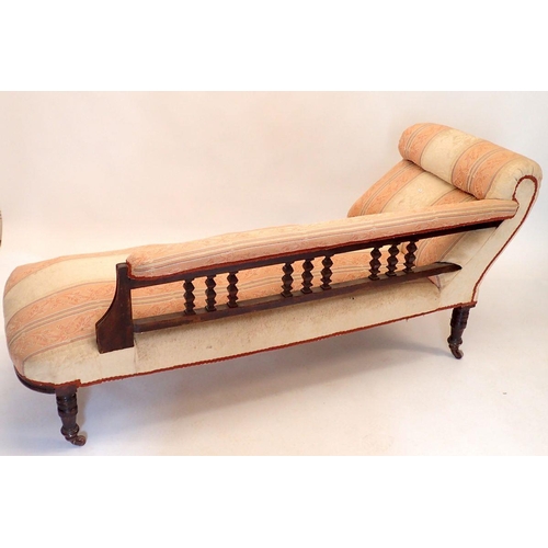 1343 - A Victorian mahogany chaise longue with carved back, all on turned supports, 170cm long