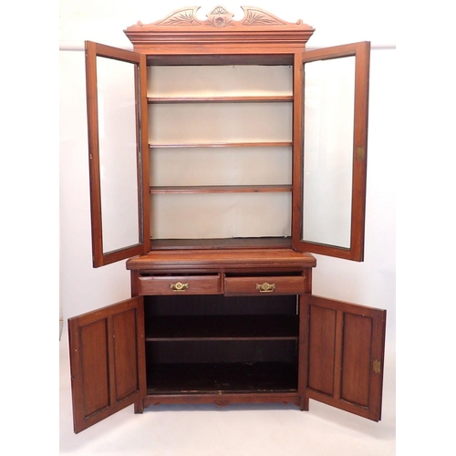 1430 - A Victorian mahogany bookcase with pair of glazed doors over carved drawers and cupboards, 106cmwide