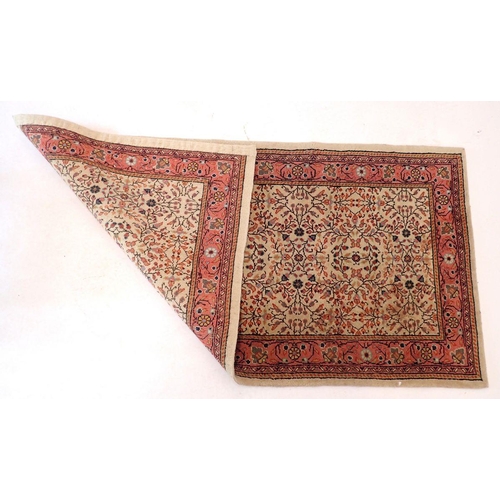 1435 - A small Persian rug with all over floral decoration on a cream ground and pick border, 140 x 73cm