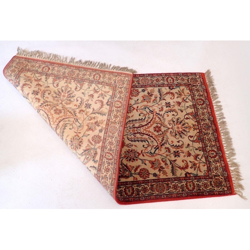 1437 - A small Persian style rug with all over floral decoration on a cream ground 152x80cm