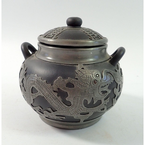 151 - A Chinese black pottery jar and cover with metal mounts, 11cm tall
