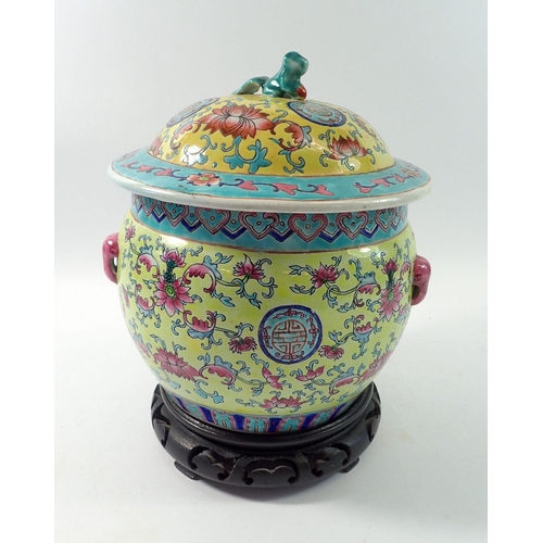 170 - A Chinese yellow ground jar and cover decorated peonies on wooden stand, 24cm tall