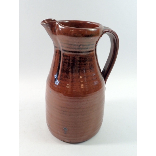 185 - A studio pottery jug with tenmoku glaze,  impressed mark, 27cm tall