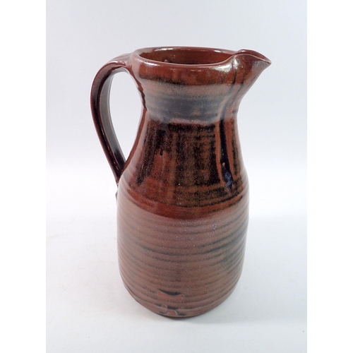 185 - A studio pottery jug with tenmoku glaze,  impressed mark, 27cm tall