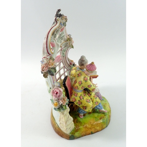 197 - A 19th century Meissen style group of Chinese couple seated reading in floral and scrollwork bower, ... 