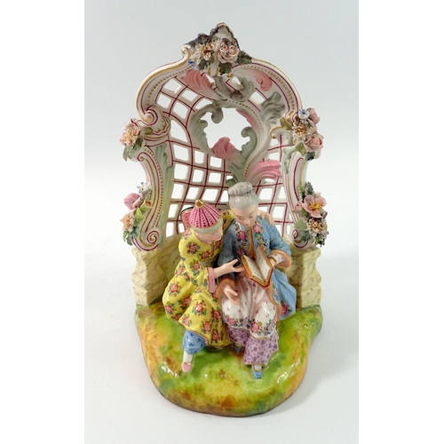 197 - A 19th century Meissen style group of Chinese couple seated reading in floral and scrollwork bower, ... 