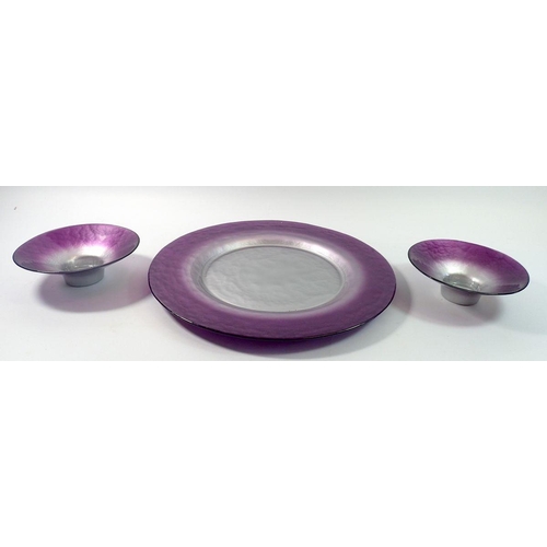 215 - A Portmeirion 'Dusk' glass charger, 34cm diameter with two smaller dishes