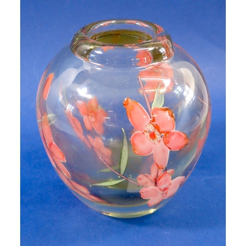 216 - A heavy glass vase with encapsulated floral decoration, 13cm tall