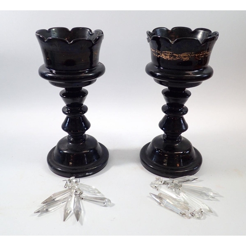 229 - A pair of Victorian black mourning glass lustres, 29cm tall