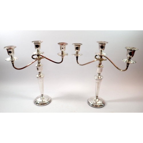 262 - Two silver plated three branch candleabras, 36cm tall