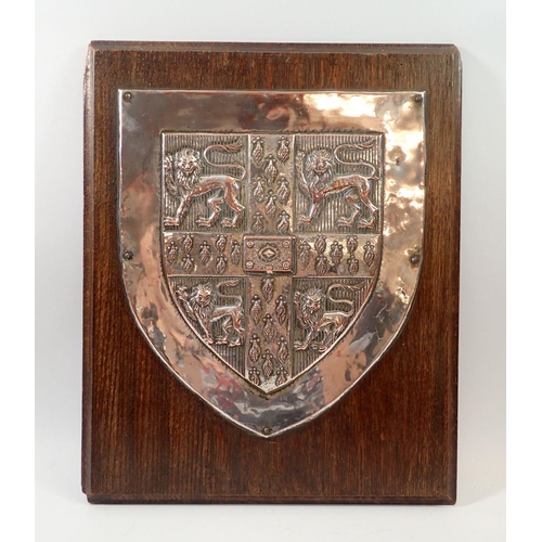 265 - A large silver plated plaque bearing the arms of Cambridge University mounted on oak panel, by Fishe... 