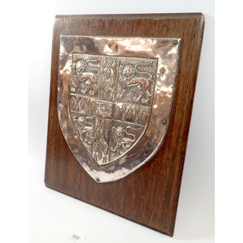 265 - A large silver plated plaque bearing the arms of Cambridge University mounted on oak panel, by Fishe... 