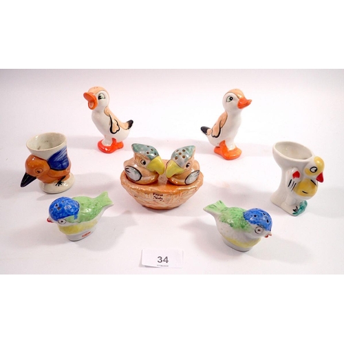 34 - A collection of Art Deco novelty bird form cruets and egg cups, tallest 9.5cm