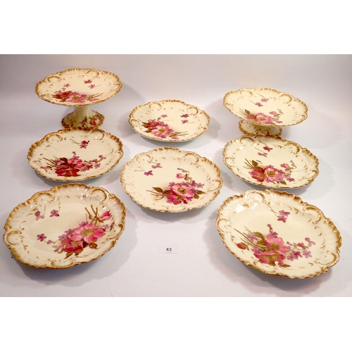 43 - A Limoges French porcelain part dessert service comprising two cake plates and six plates on a cream... 
