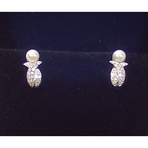 448 - A pair of 14 carat white gold earrings set pearl and chip diamonds, 2.5g