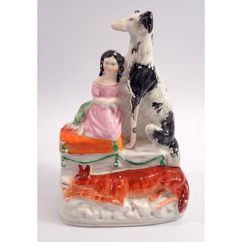 56 - A Staffordshire group of Prince Llewellyn's son and his faithful dog Gelert, 22cm tall