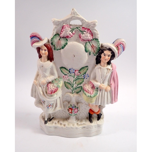 58 - A Victorian Staffordshire clock group of man and woman with flowers, 30cm tall