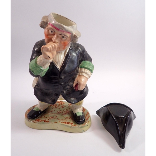 61 - A large Victorian Staffordshire Toby figure in the form of a man taking snuff with tricorn hat lid, ... 