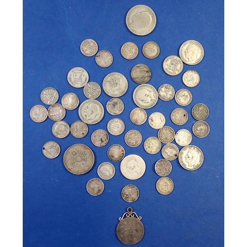 710 - A group of British silver coins including Anne shilling mounted as pendant, Victoria - George VI thr... 