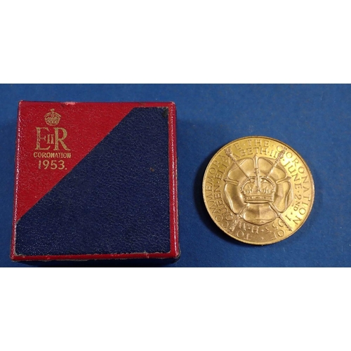 764 - An Elizabeth II Coronation 1953 proof coin set in maroon case plus a cased coronation medal