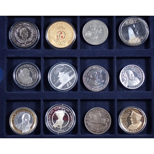 768 - A collection of boxed commemorative coins including some silver Westminster examples, Churchill, D-D... 