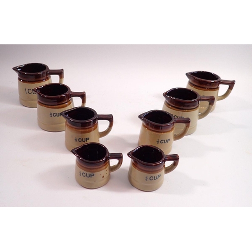 88 - Two sets of four graduated pottery measuring jugs, 1/4, 1/2. 3/4 and 1 cup (8)