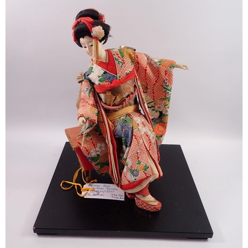 1114 - A Japanese Bijin vintage seated costume doll with silk costume, 38cm tall