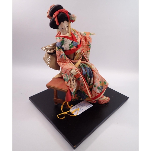 1114 - A Japanese Bijin vintage seated costume doll with silk costume, 38cm tall