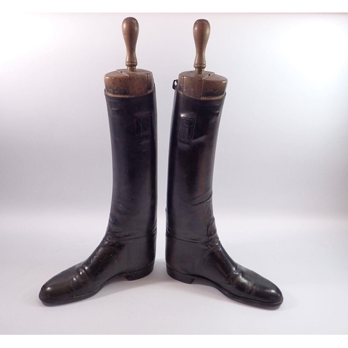 1171 - A pair of early 20th century black leather riding boots with wooden trees and boot jacks