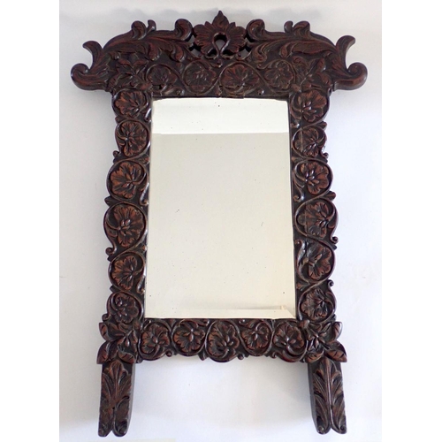 1007 - A floral and foliage carved oak framed mirror, 71 x 49cm