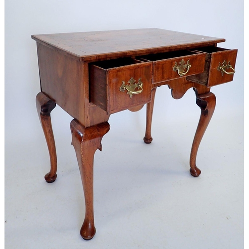 1012 - A George II walnut lowboy with one short and two deep drawers, with shaped frieze and raised on cabr... 