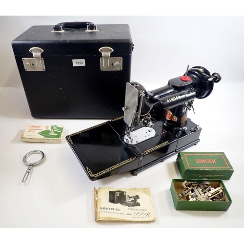 1013 - A Singer sewing machine 222K Featherweight with accessories, instructions, mat and case