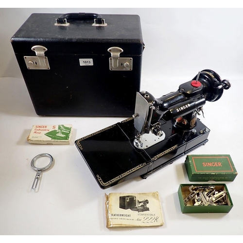 1013 - A Singer sewing machine 222K Featherweight with accessories, instructions, mat and case