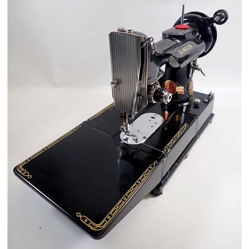 1013 - A Singer sewing machine 222K Featherweight with accessories, instructions, mat and case