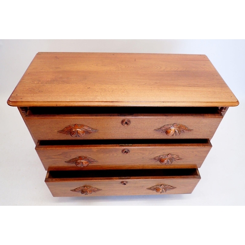 1014 - A continental oak chest of three drawers with carved handles, 102cm