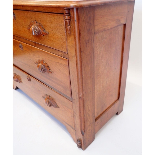 1014 - A continental oak chest of three drawers with carved handles, 102cm