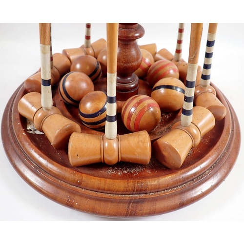 1019 - A Victorian table croquet set on turned mahogany  stand with mallets, balls, clamps and hoops