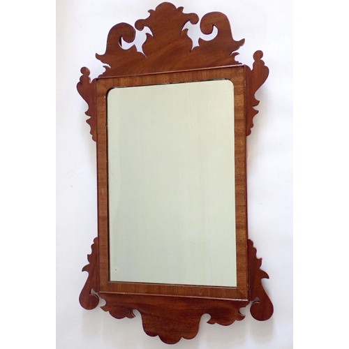 1029 - A mahogany Chippendale style wall mirror with scroll pediment and apron, 75 x 43cm