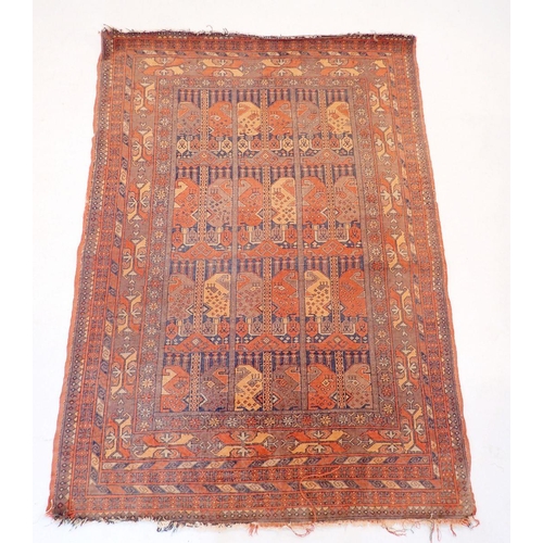 1031 - An unusual antique Turkoman rug with small geometric panels within multiple floral and geometric bor... 