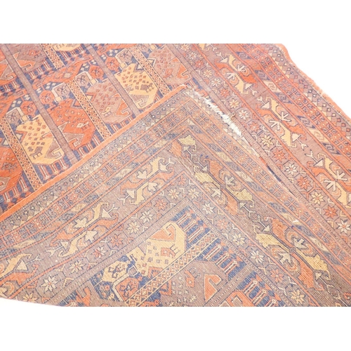 1031 - An unusual antique Turkoman rug with small geometric panels within multiple floral and geometric bor... 