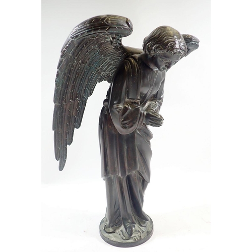 1040 - A 19th century bronze model of a winged angel on circular base, 38cm high