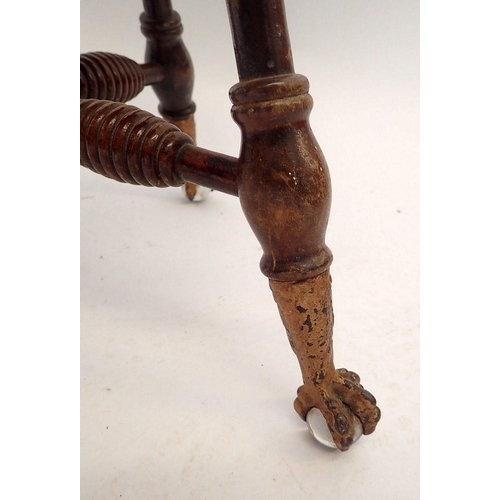 1042 - An American or Canadian mahogany revolving piano stool with gilt metal claw and glass ball feet