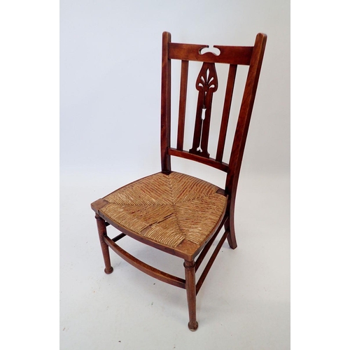 1043 - An Edwardian rush seated nursing chair with pierced splat back