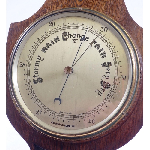 1045 - An oak aneroid banjo barometer with silvered dial and thermometer, 88cm tall