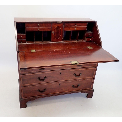 1047 - A Georgian style mahogany bureau, the slope front enclosing fitted interior with drawers, central cu... 